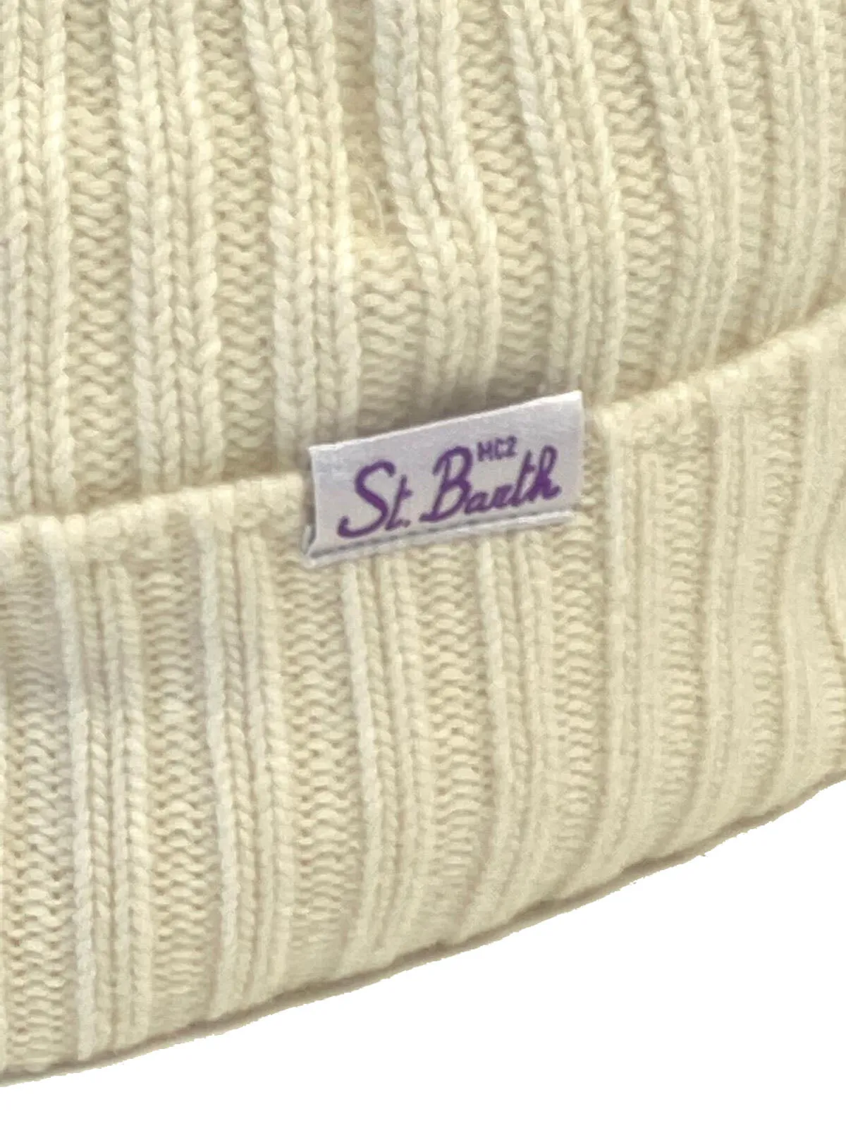 White embroidered women's ski beanies with pom poms.